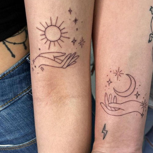 Twin Flame Tattoos with a hand each holding sun and moon