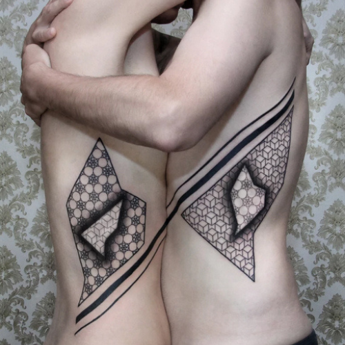 couple tattoo triangle art across bodies