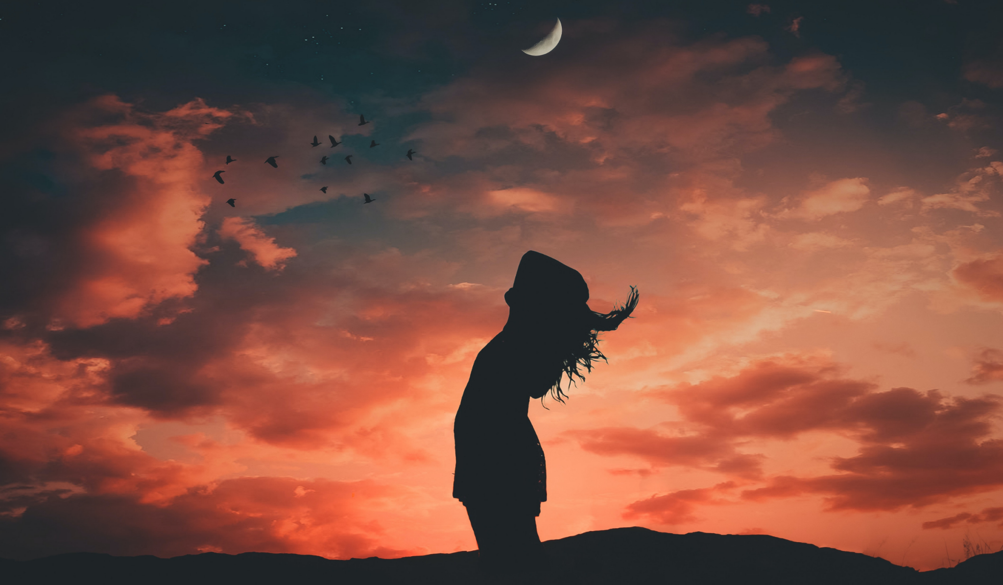 woman looking at the sky at dawn