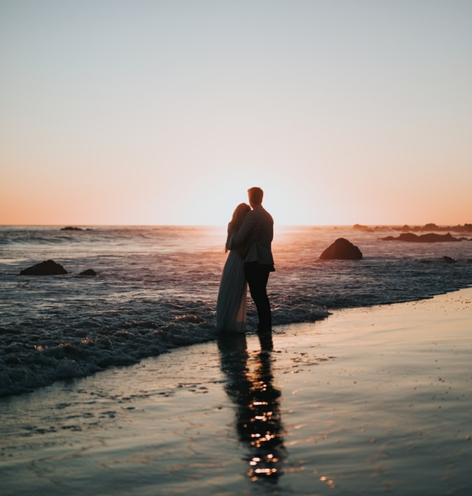 couple looking at sunset on the beach