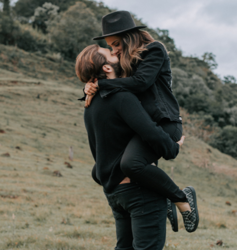 man carrying and kissing his woman