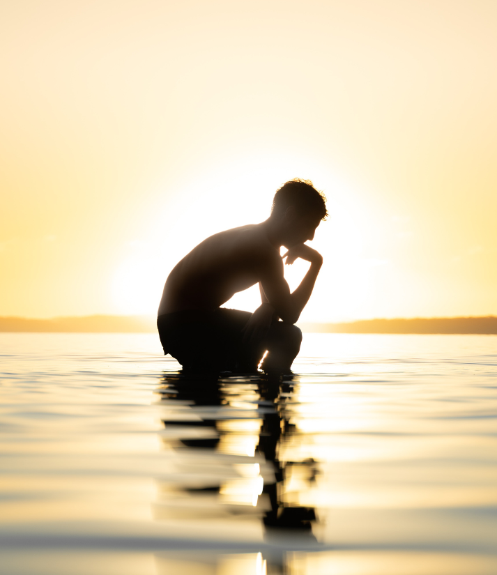 man in the water being pensive