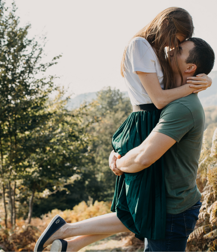 man lifting his woman in his embrace