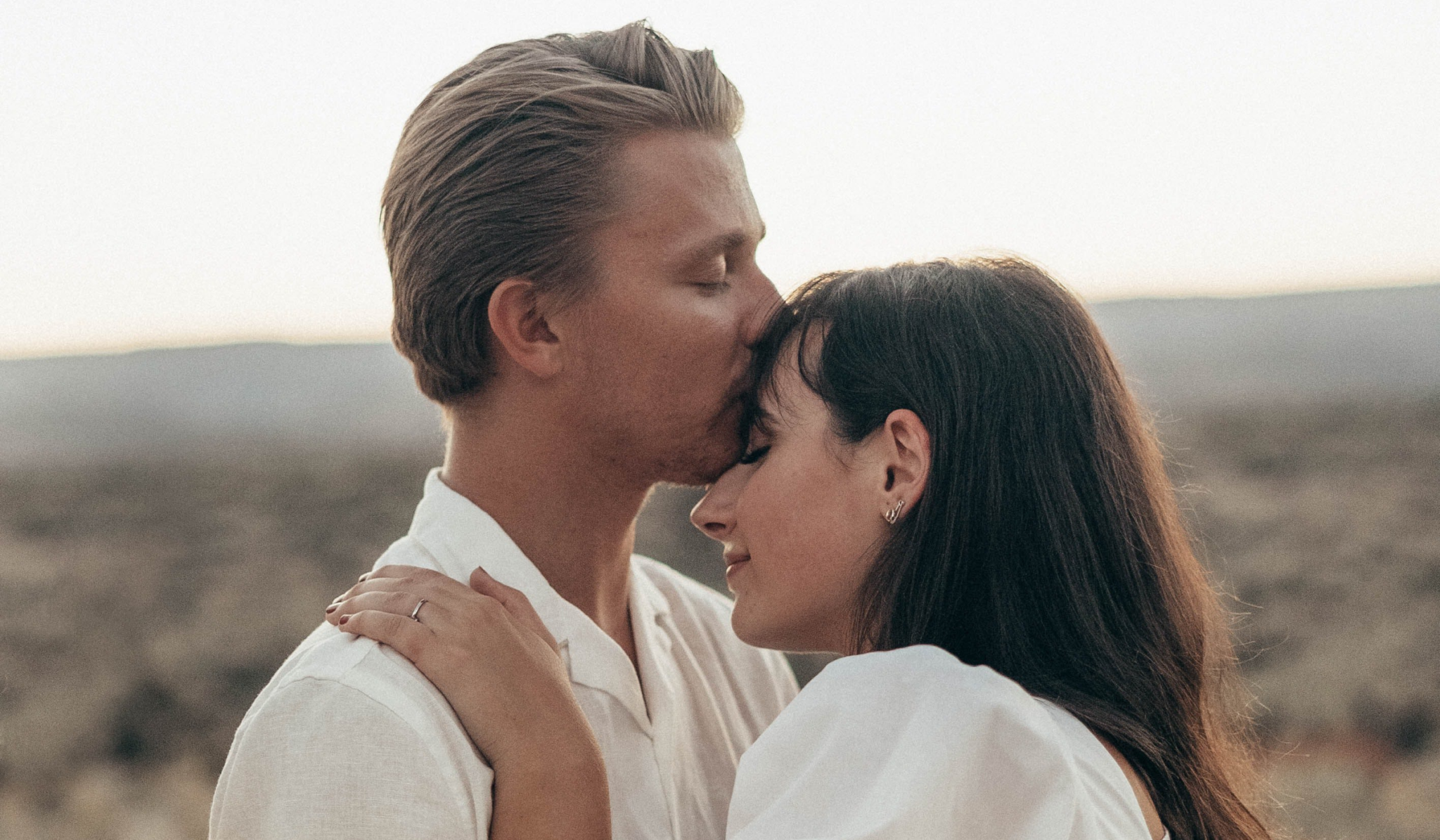 divine masculine kissing her forehead